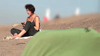 naomi1 handjob a young guy on a public beach