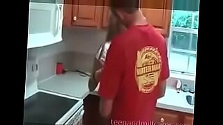 son helps mom behind in kitchen