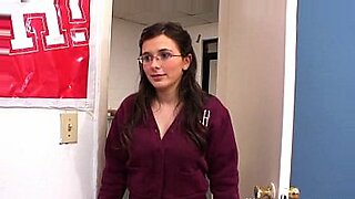 girl with glasses gives blowjob at video store