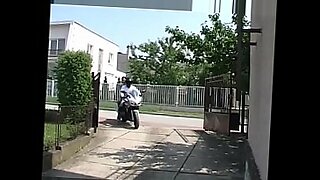 group of swinging couples playing with water guns outdoors