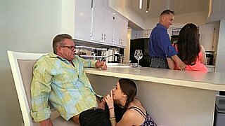 woman shocks a tied up man bound in ropes who has his cock in chastity device
