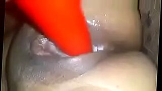 woman shocks a tied up man bound in ropes who has his cock in chastity device