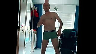 woman shocks a tied up man bound in ropes who has his cock in chastity device