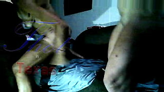 woman shocks a tied up man bound in ropes who has his cock in chastity device