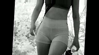 woman shocks a tied up man bound in ropes who has his cock in chastity device