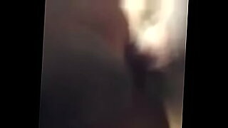 woman shocks a tied up man bound in ropes who has his cock in chastity device